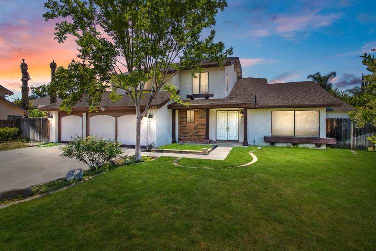 A charming house in San Bernardino with a well-kept lawn, representing homes we purchase for cash.
